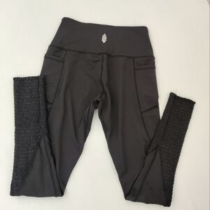 Free People Movement Black Leggings with Smocking bottoms.